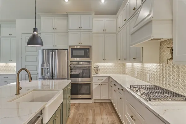 a kitchen with cabinets and appliances