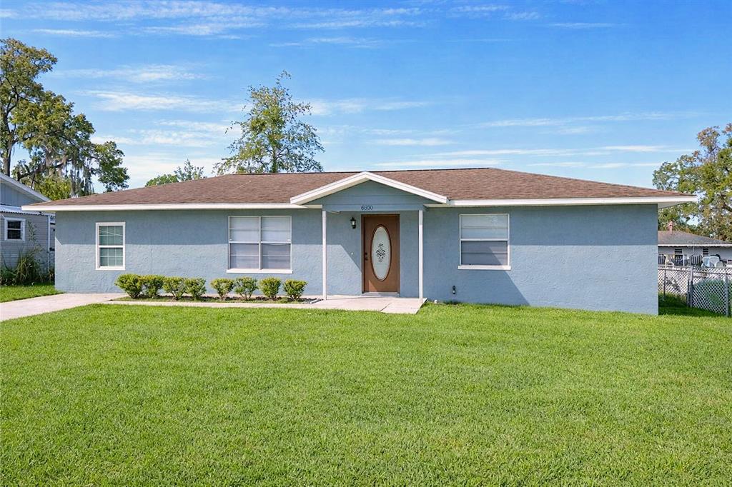 8800 Southeast 89th Place Ocala, FL 34472 - Photo 1 of 18 a front view of a house with a garden