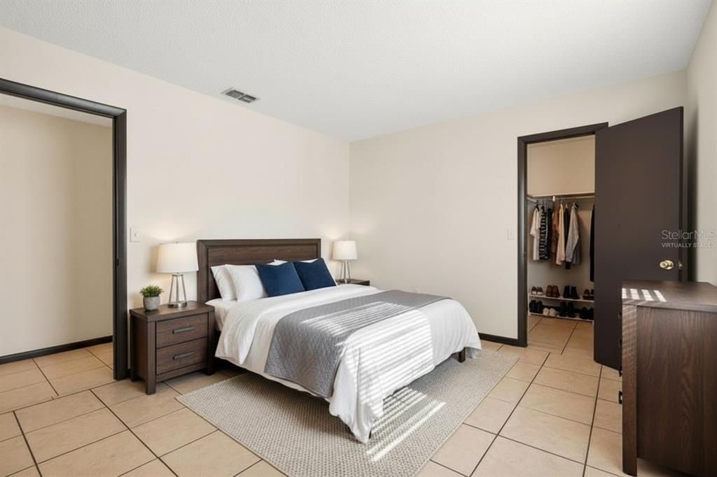 8800 Southeast 89th Place Ocala, FL 34472 - Photo 14 of 18 a bedroom with a bed and a walk in closet