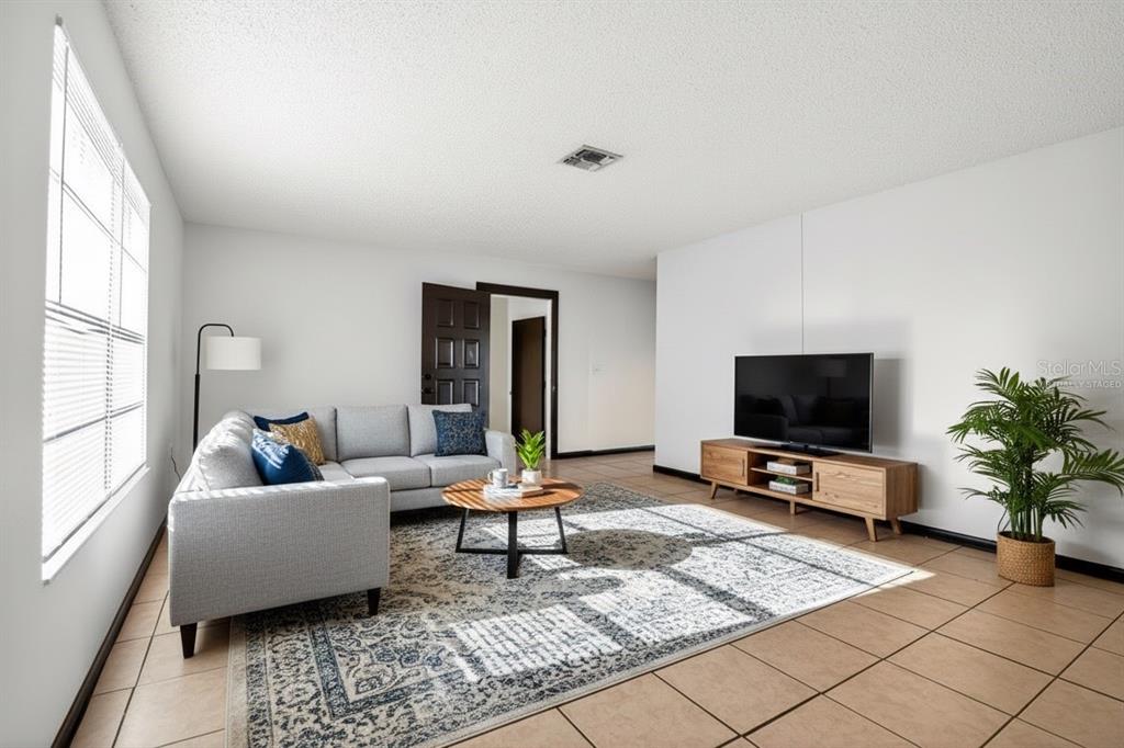 8800 Southeast 89th Place Ocala, FL 34472 - Photo 3 of 18 a living room with furniture and a flat screen tv