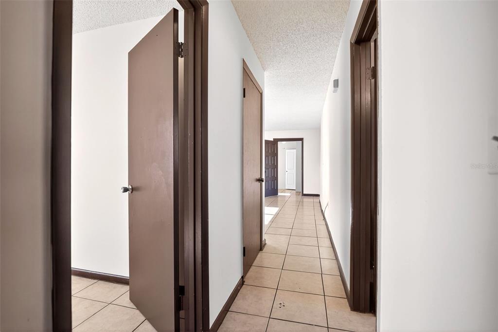 8800 Southeast 89th Place Ocala, FL 34472 - Photo 7 of 18 a view of a hallway with a black and white walls