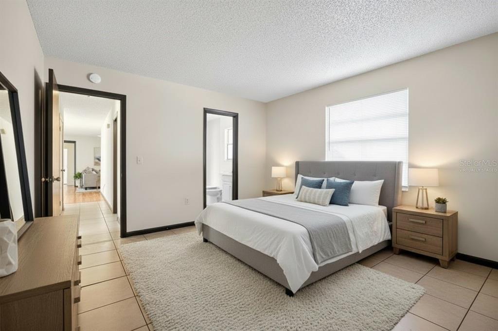 8800 Southeast 89th Place Ocala, FL 34472 - Photo 8 of 18 a bedroom with a bed a mirror and a couch
