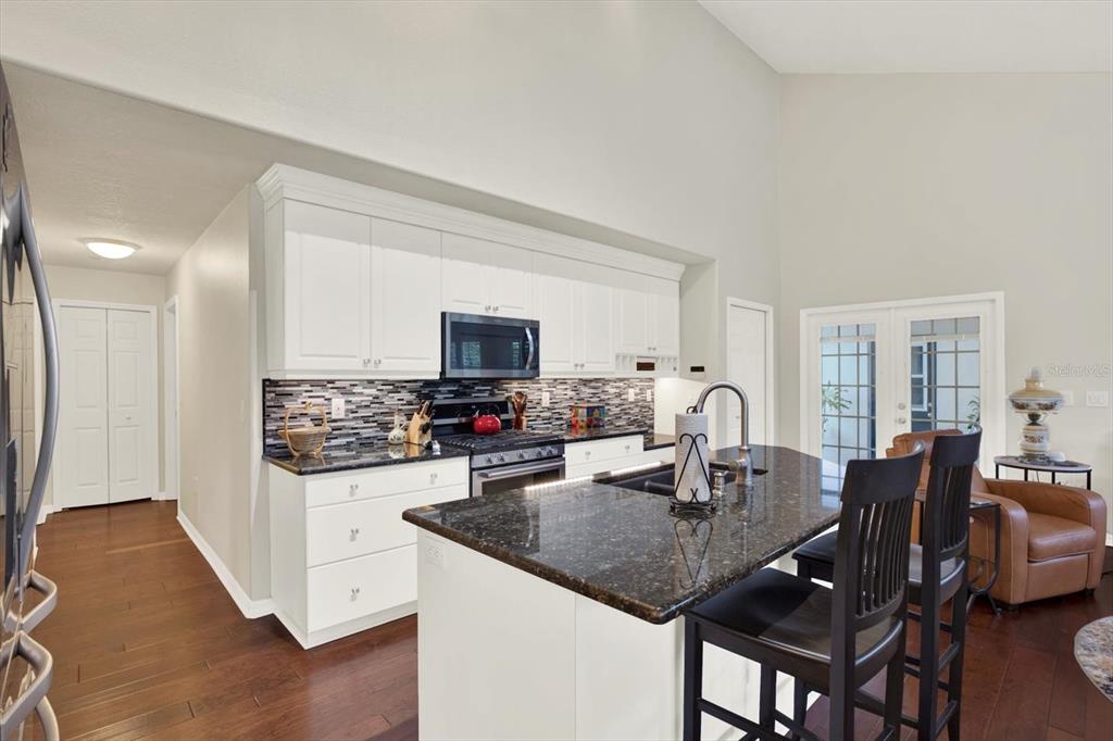 2021 Meadow Rue Court Trinity, FL 34655 - Photo 10 of 41 a kitchen with a dining table chairs and a refrigerator