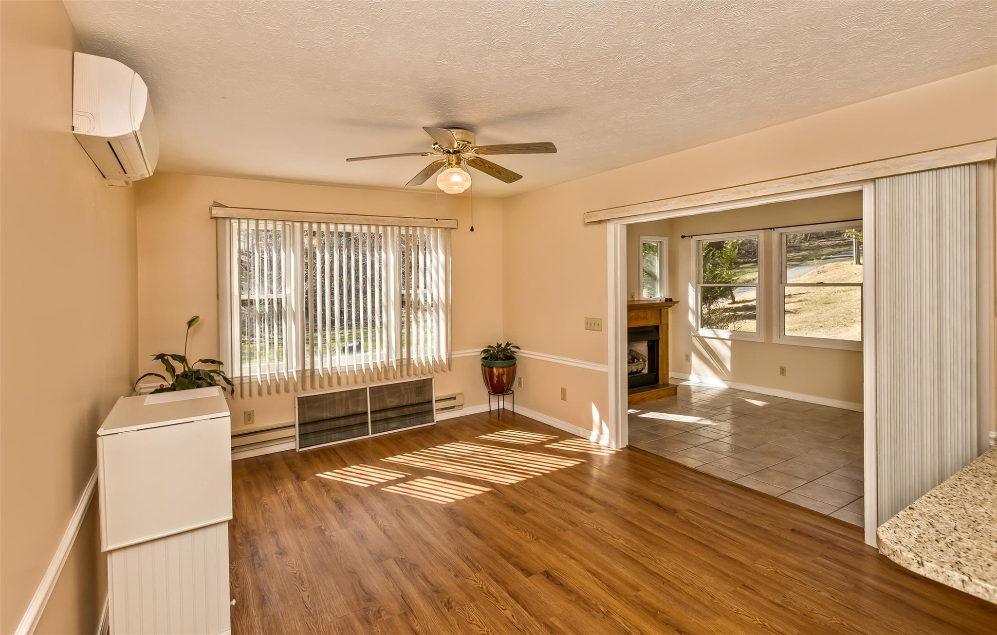 124 Beaverdam Loop Road Candler, NC 28715 - Photo 11 of 25 a view of an empty room with wooden floor and a window
