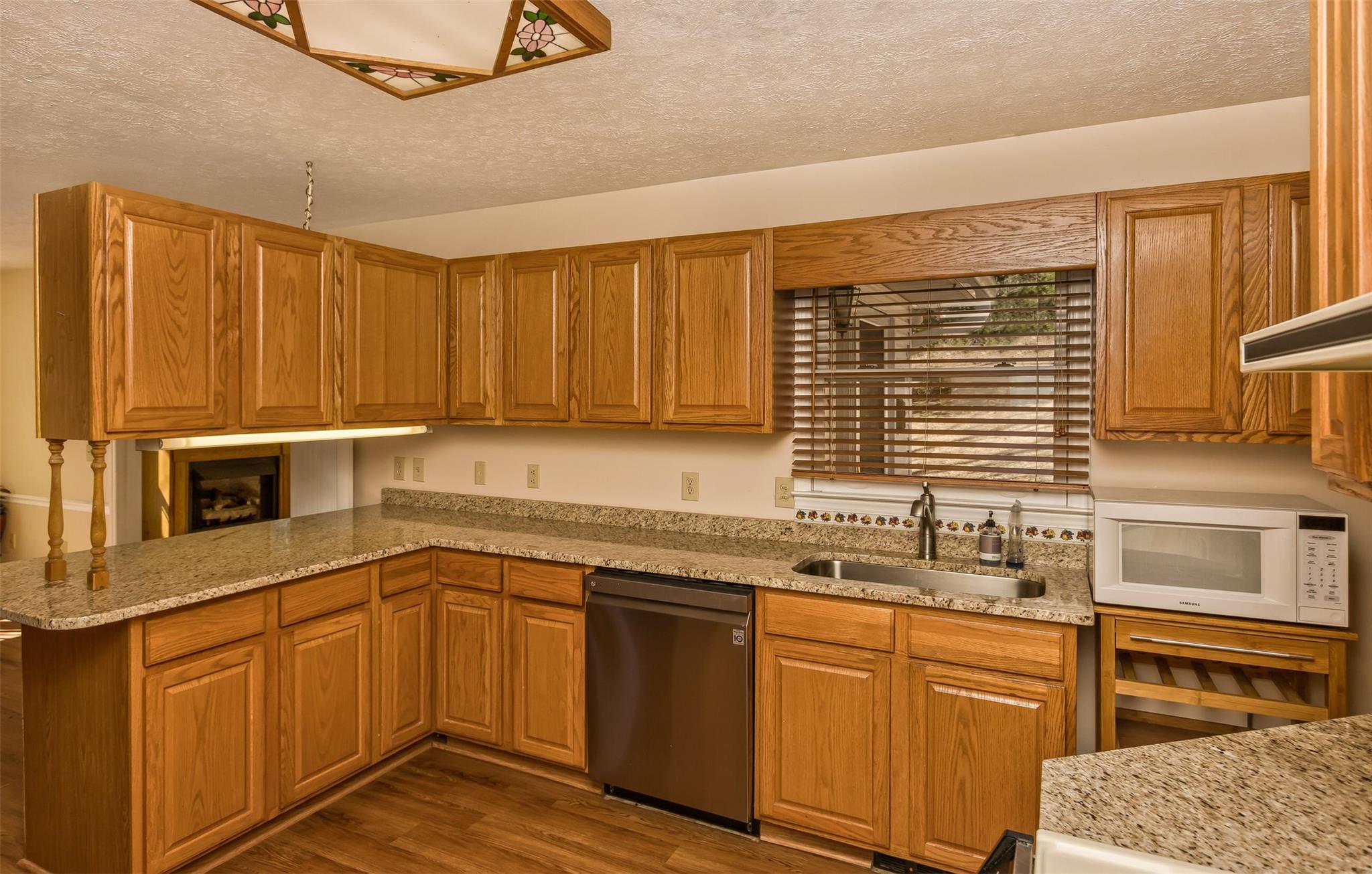 124 Beaverdam Loop Road Candler, NC 28715 - Photo 14 of 25 a kitchen with stainless steel appliances granite countertop a sink a stove and cabinets