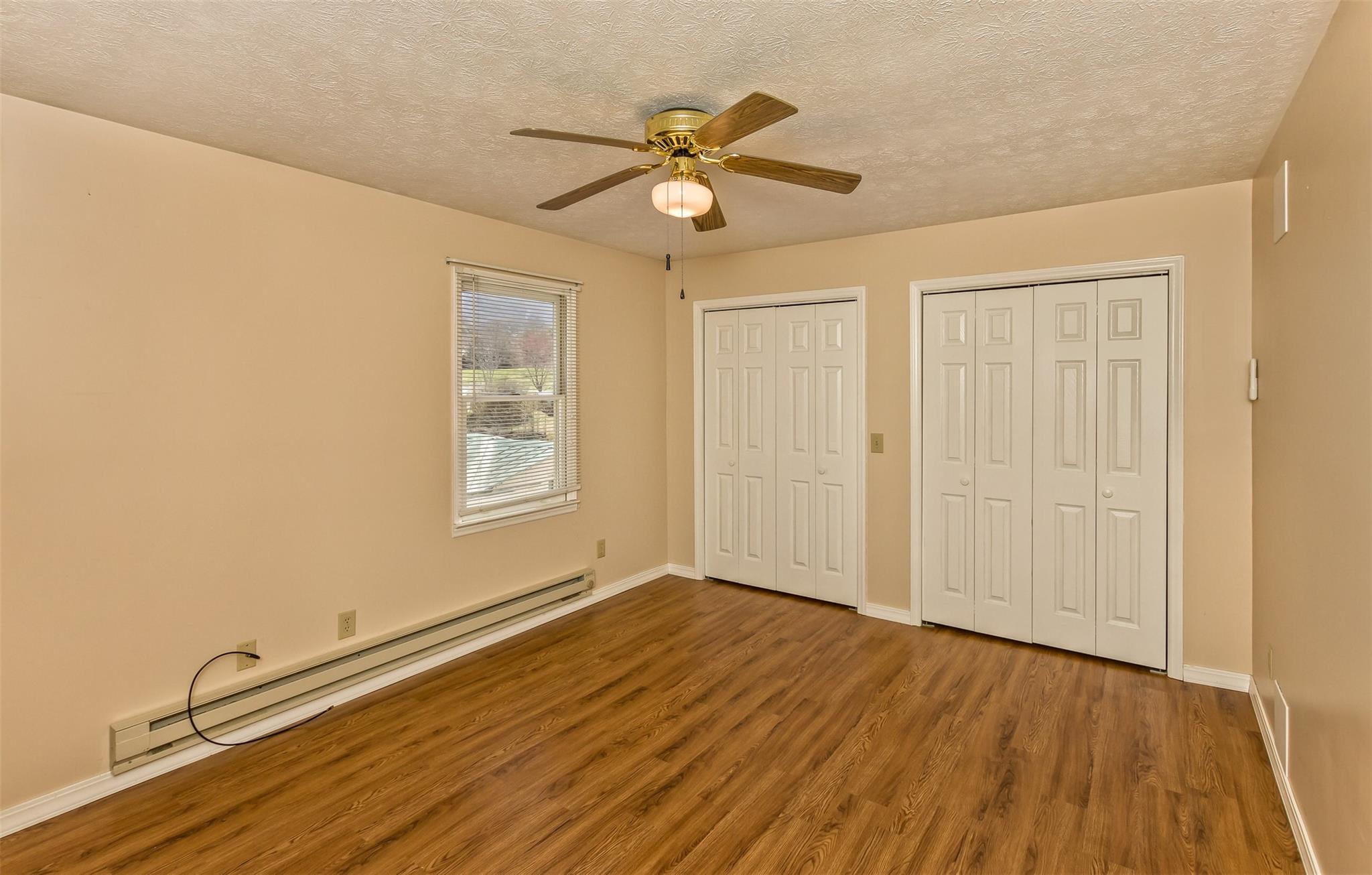 124 Beaverdam Loop Road Candler, NC 28715 - Photo 17 of 25 a view of an empty room with wooden floor and a window
