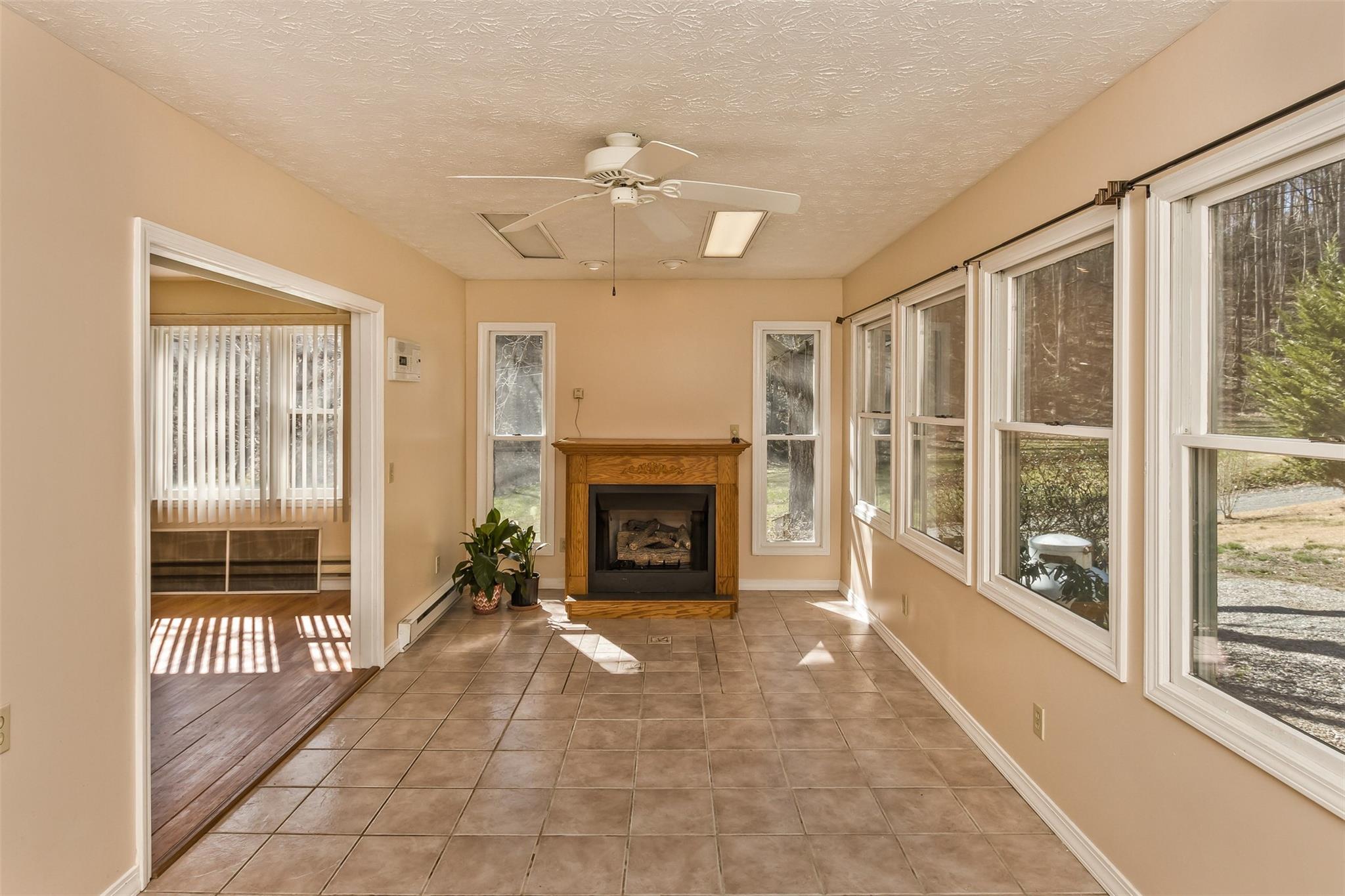 124 Beaverdam Loop Road Candler, NC 28715 - Photo 9 of 25 a view of an empty room with a fireplace and a window