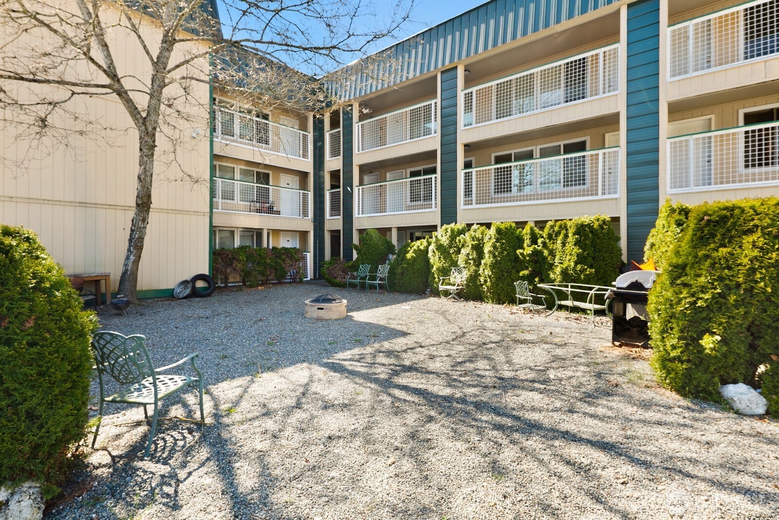 101 Southwest 119th Street, Unit 102 Burien, WA 98146 - Photo 3 of 15 a view of a building with a yard