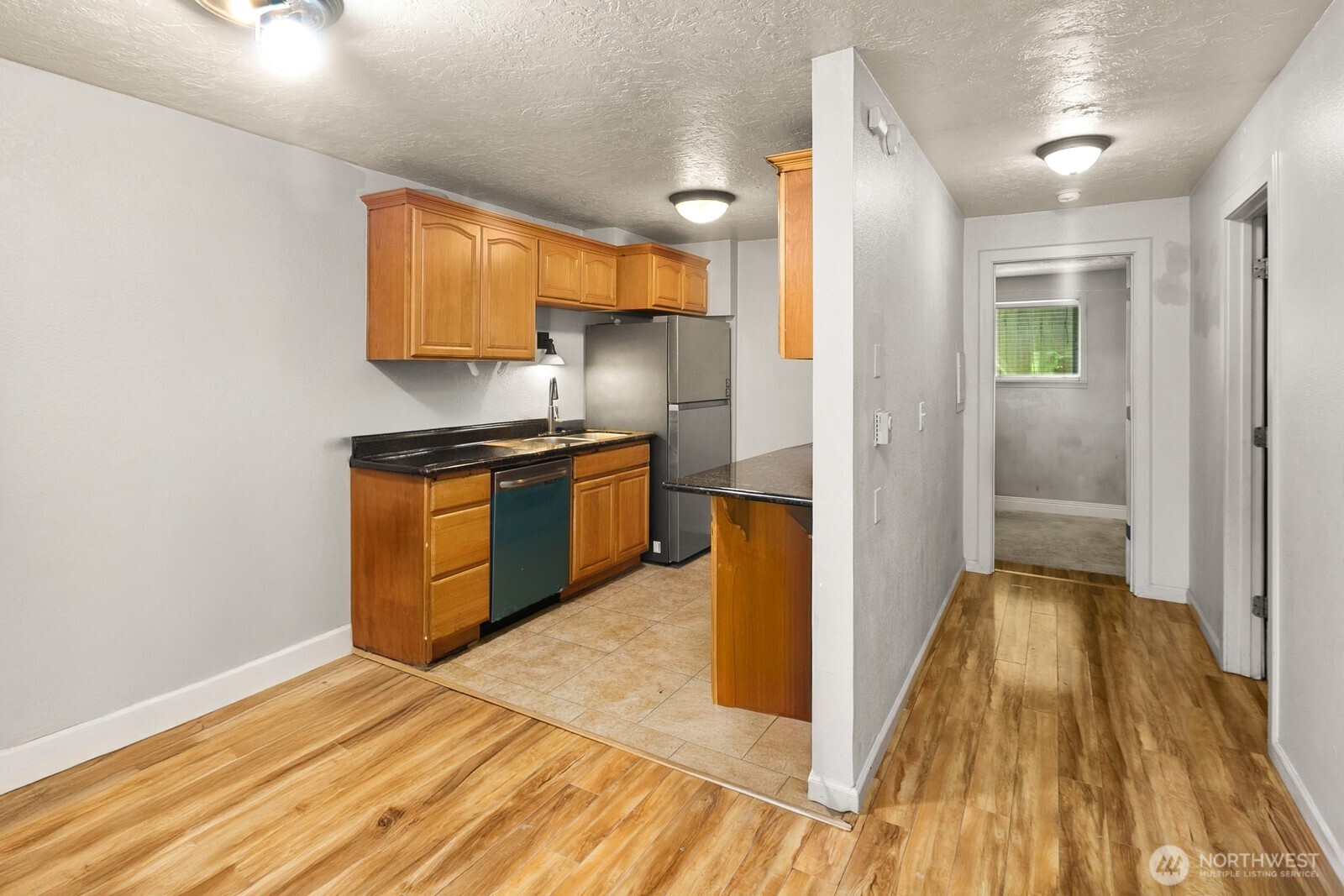 101 Southwest 119th Street, Unit 102 Burien, WA 98146 - Photo 8 of 15 a view of a kitchen from the hallway