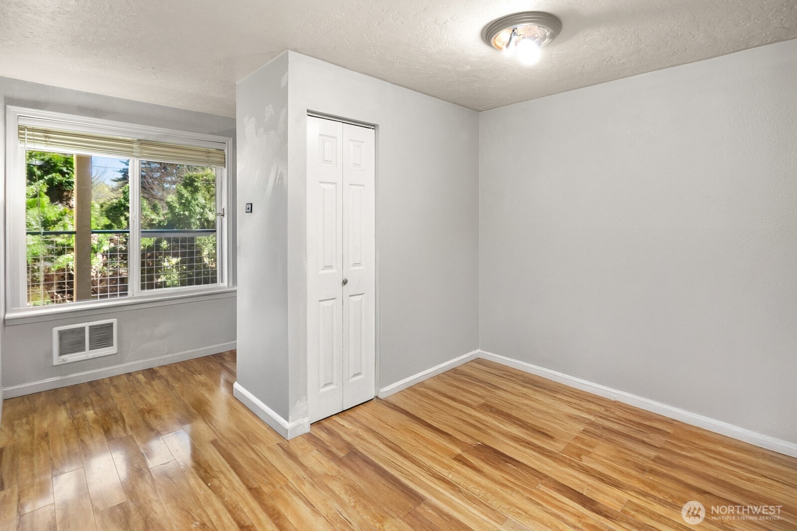 101 Southwest 119th Street, Unit 102 Burien, WA 98146 - Photo 9 of 15 a view of empty room with wooden floor and fan