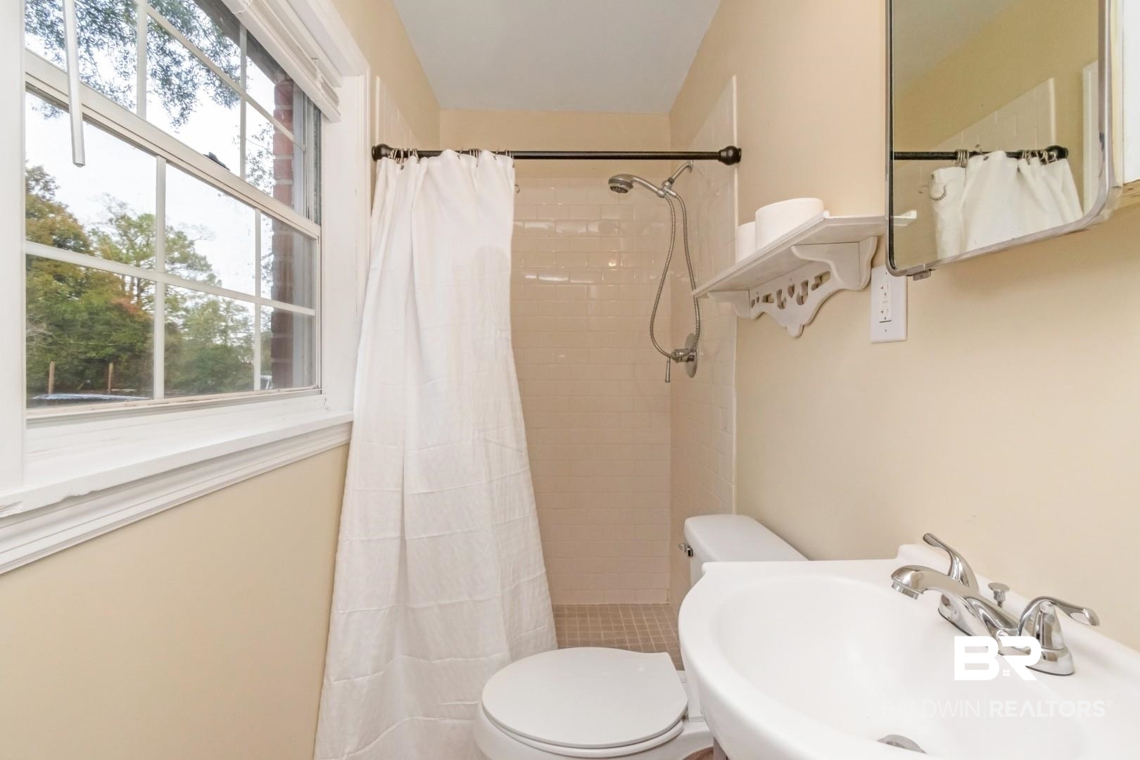 61 Nack Lane Mobile, AL 36608 - Photo 15 of 25 Bathroom featuring toilet, sink, and a shower with shower curtain