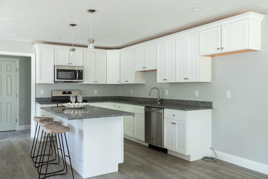 11 Indian Neck Road Wareham, MA 02571 - Photo 15 of 41 a kitchen with stainless steel appliances granite countertop a sink stove and microwave