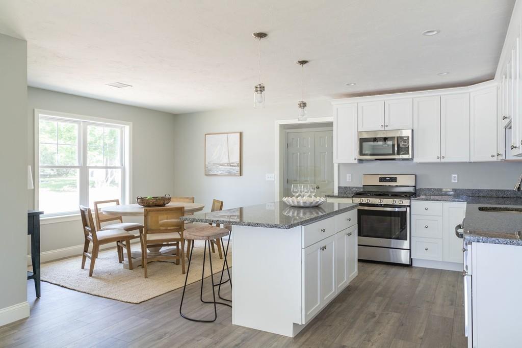 11 Indian Neck Road Wareham, MA 02571 - Photo 16 of 41 a kitchen with granite countertop white cabinets and white appliances