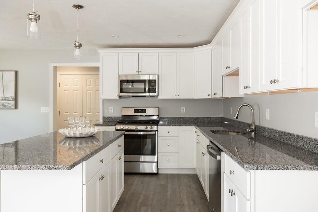 11 Indian Neck Road Wareham, MA 02571 - Photo 17 of 41 a kitchen with stainless steel appliances granite countertop a sink stove and cabinets