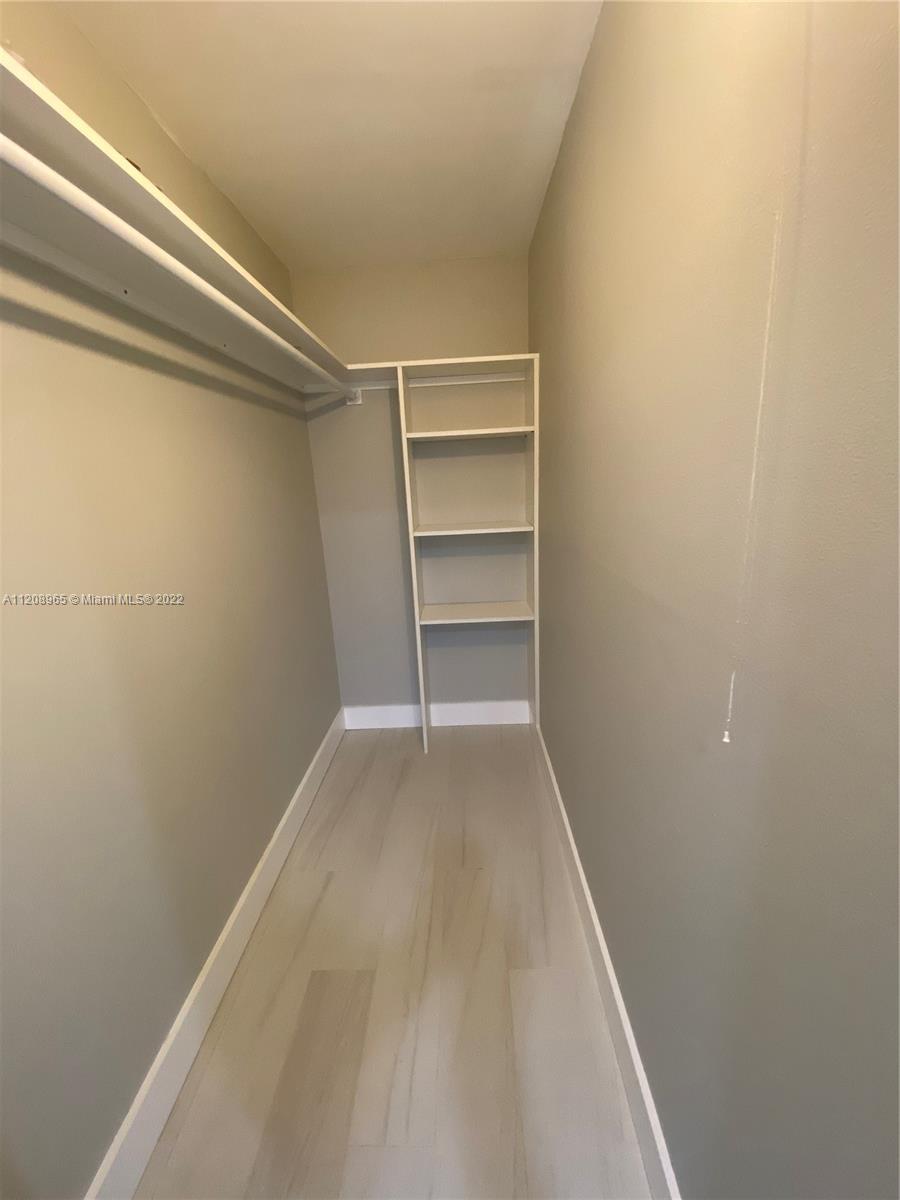 1058 Guildford East, Unit 1058 Boca Raton, FL 33434 - Photo 13 of 14 a view of a room with rack on the wall