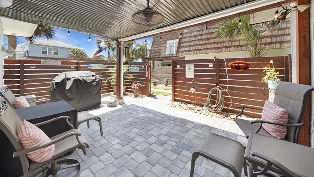 a view of a chairs and a table in the patio
