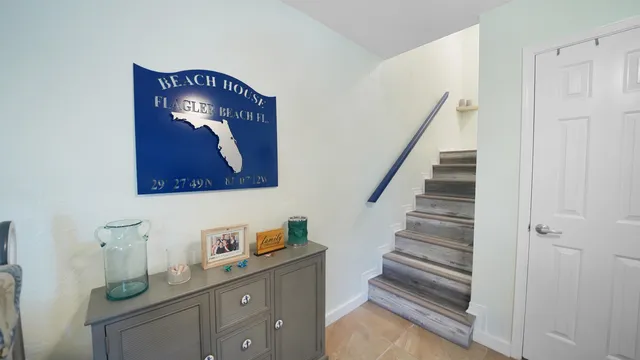 a view of staircase with white cabinets and wooden floor