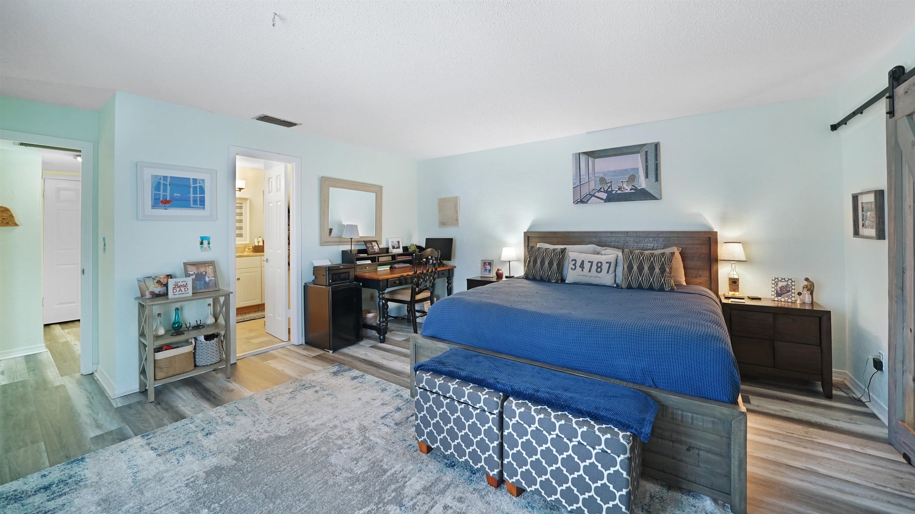 111 South 18th Street Flagler Beach, FL 32136 - Photo 20 of 38 a bedroom with a bed and wooden floor