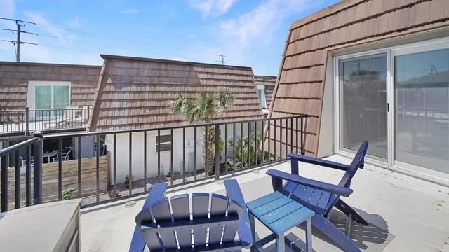 a view of a chair and table in the balcony