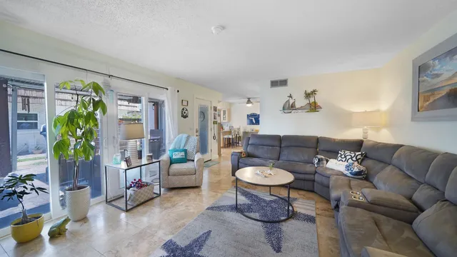a living room with furniture and a potted plant