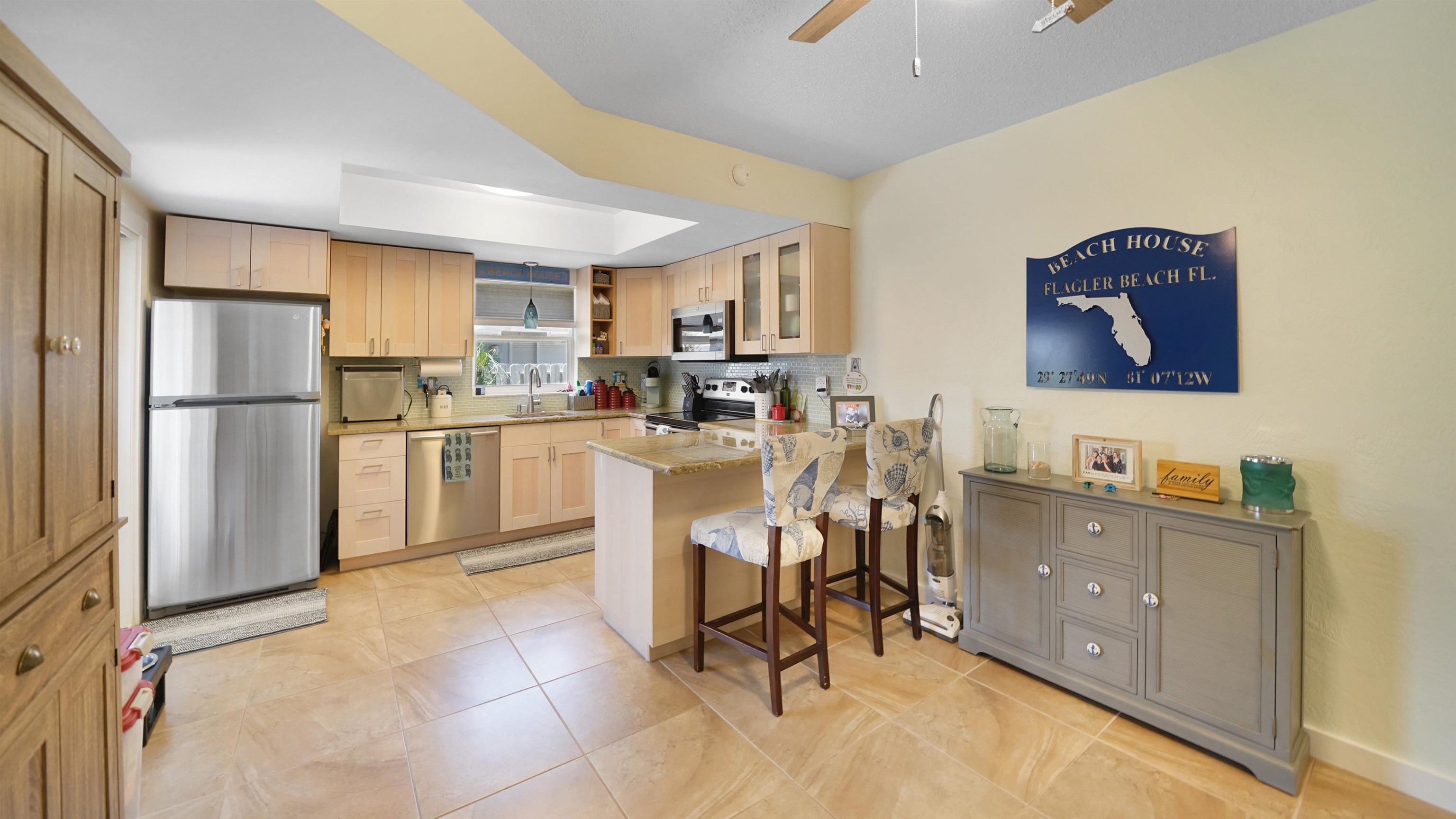 111 South 18th Street Flagler Beach, FL 32136 - Photo 5 of 38 a kitchen with a sink a refrigerator and chairs