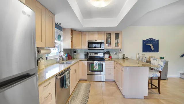a kitchen with a sink cabinets and stainless steel appliances