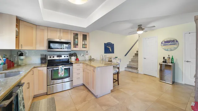 a kitchen with a sink cabinets and stainless steel appliances