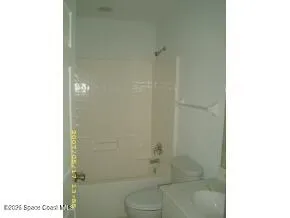 a bathroom with a shower and a toilet