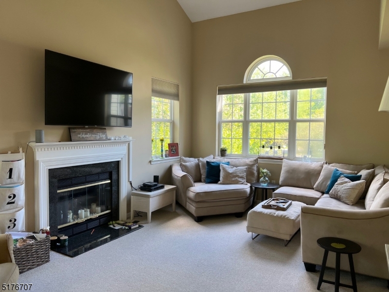 18 Hansom Road Bernards, NJ 07920 - Photo 4 of 12 a living room with furniture a flat screen tv and a fireplace