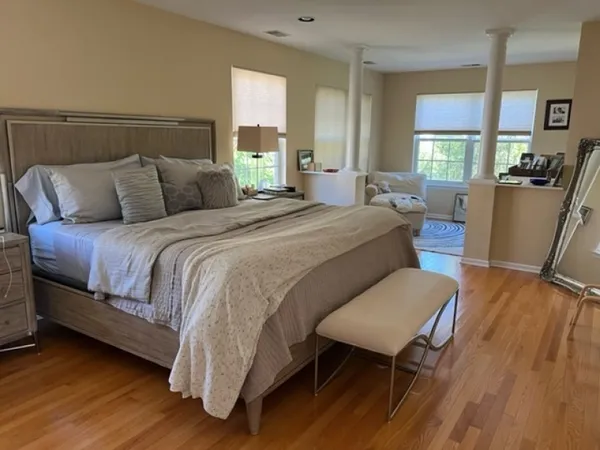 a bed room with a bed window and a chair