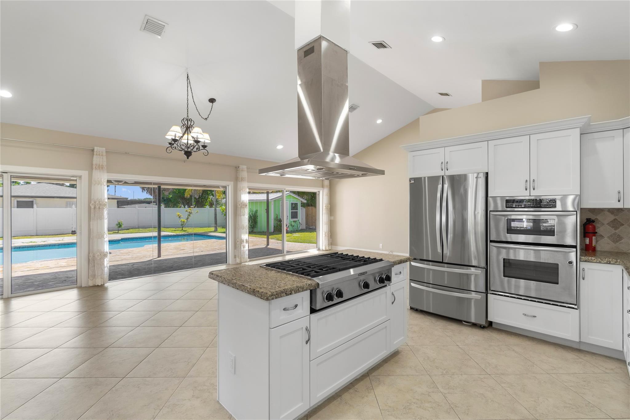 698 Northwest 12th Road Boca Raton, FL 33486 - Photo 2 of 20 Open kitchen with pool view