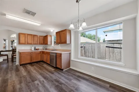 a large kitchen with kitchen island a large counter space a sink appliances and cabinets