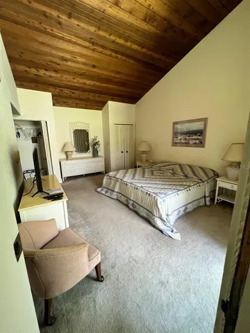 a bedroom with bed couch and window