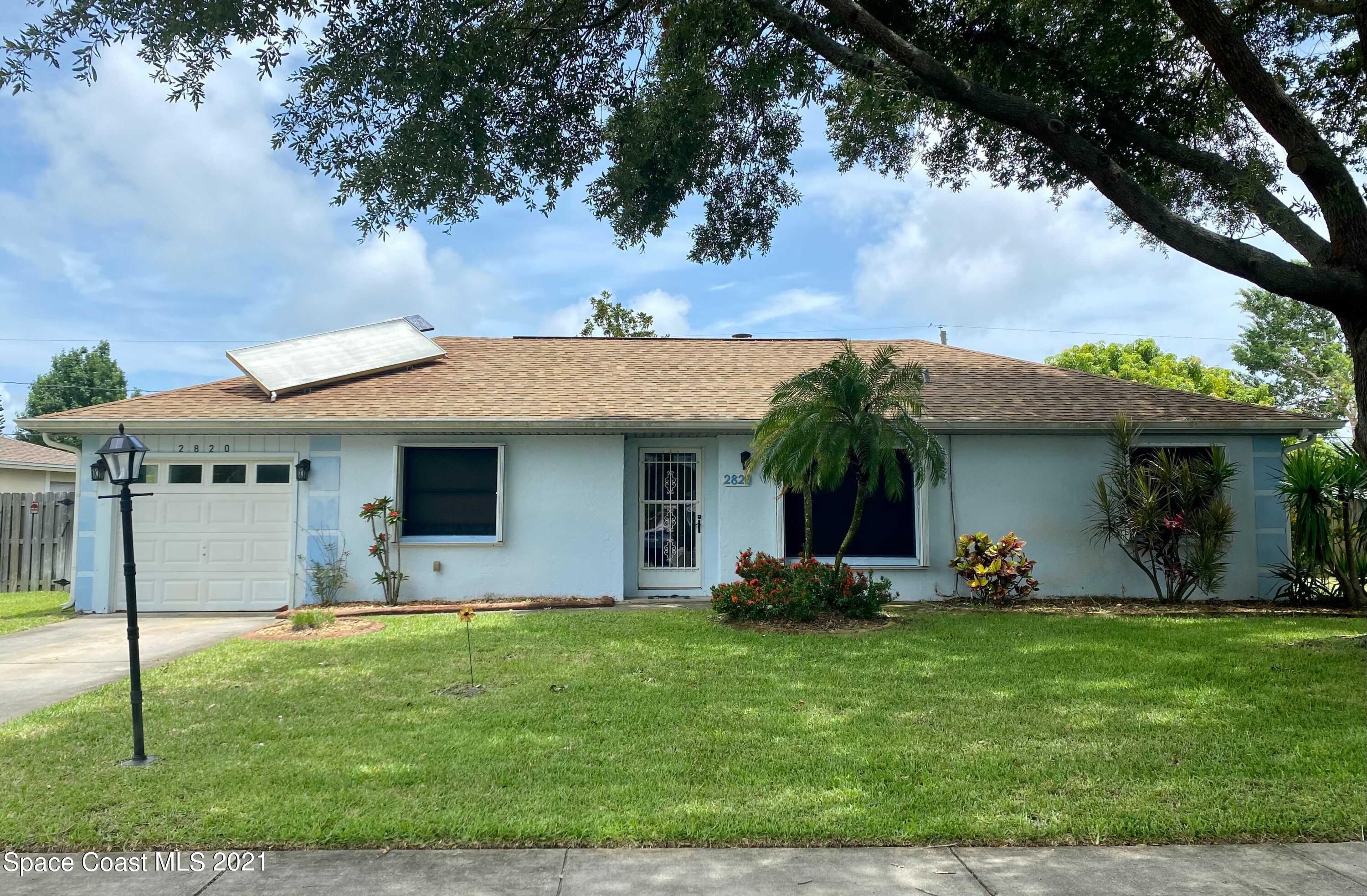 2820 Locksley Road Melbourne, FL 32935 - Photo 1 of 6 a front view of house with yard
