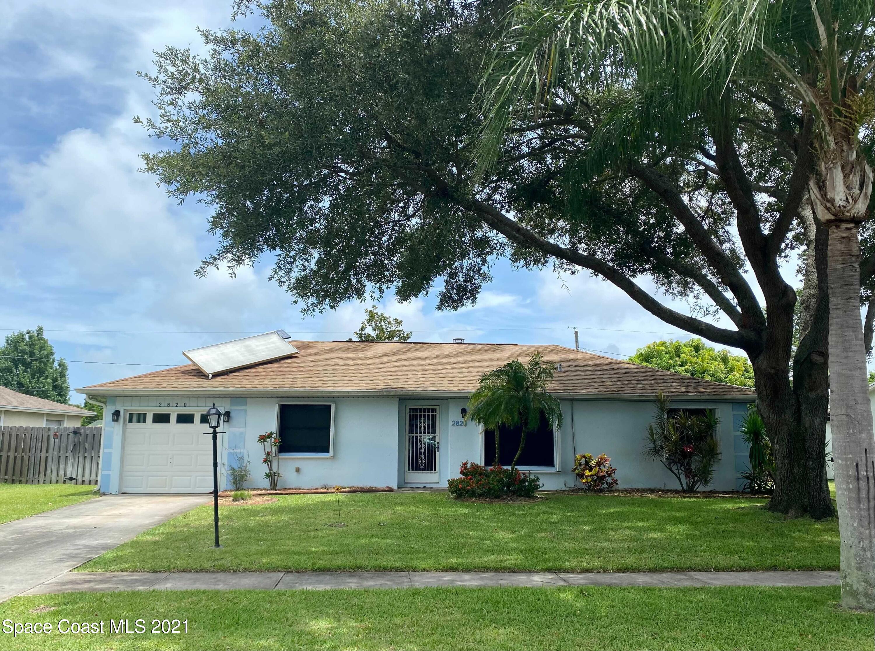 2820 Locksley Road Melbourne, FL 32935 - Photo 2 of 6 a view of a house with a yard and sitting area