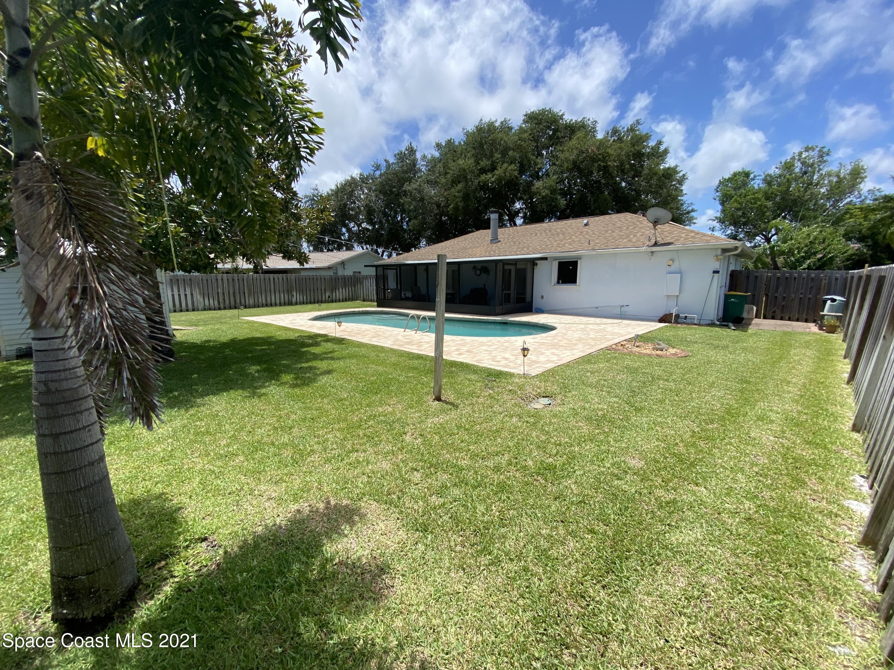 2820 Locksley Road Melbourne, FL 32935 - Photo 5 of 6 a backyard of a house with table and chairs