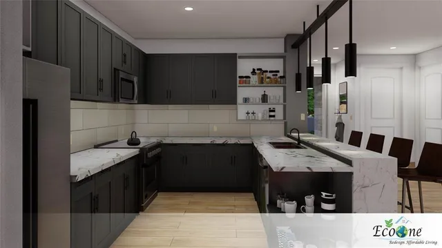 a kitchen with stainless steel appliances kitchen island granite countertop a refrigerator and a sink