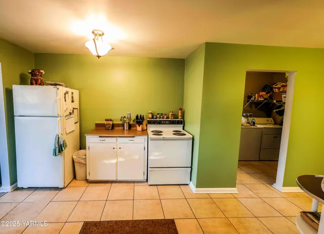 a kitchen with a refrigerator and cabinets