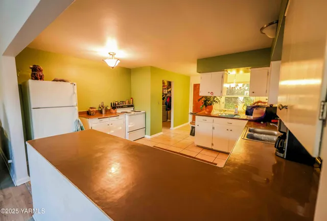 a view of a living room and kitchen with a sink