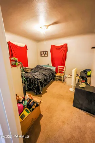 a view of a living room with closet and a flat screen tv