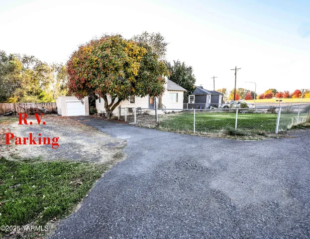 a view of a park that has large trees