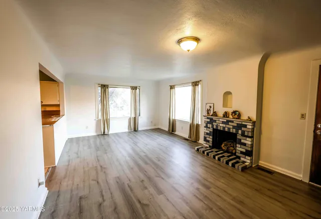 a view of a livingroom with hardwood floor and a window