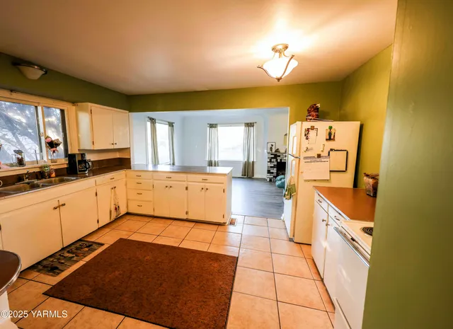 a large kitchen with cabinets and wooden floor