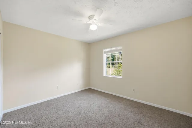 a bathroom with a granite countertop sink a toilet and a mirror
