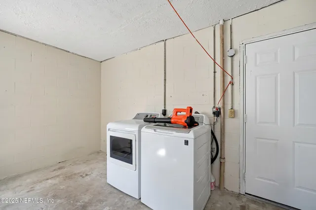 a view of an empty room with a window and cabinet