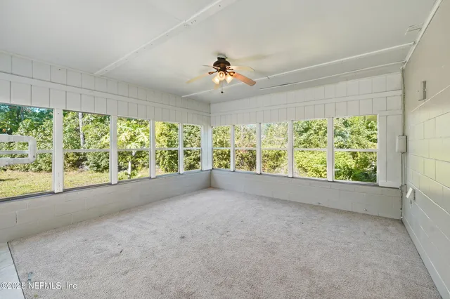 a view of a patio with table and chairs
