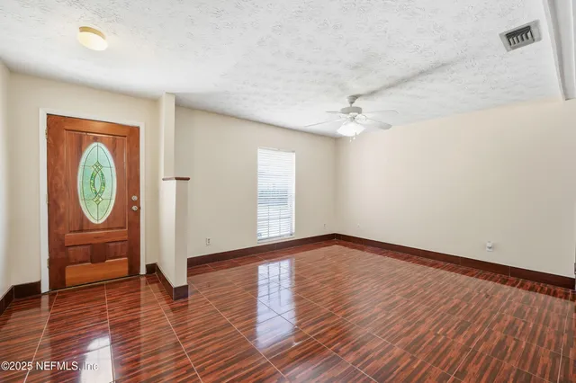 wooden floor fireplace and natural light in room