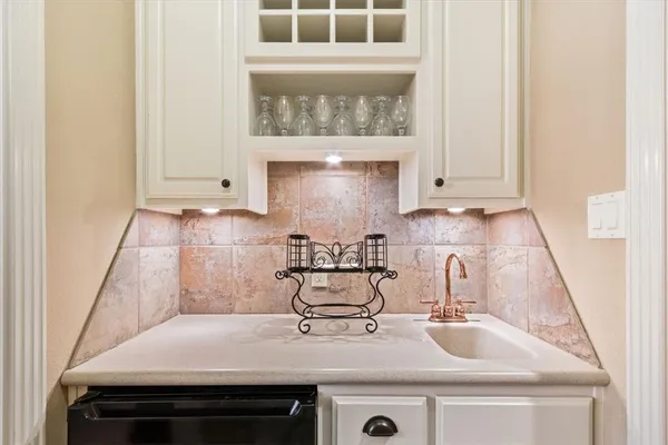 a kitchen with stainless steel appliances kitchen island granite countertop a dining table chairs and white cabinets