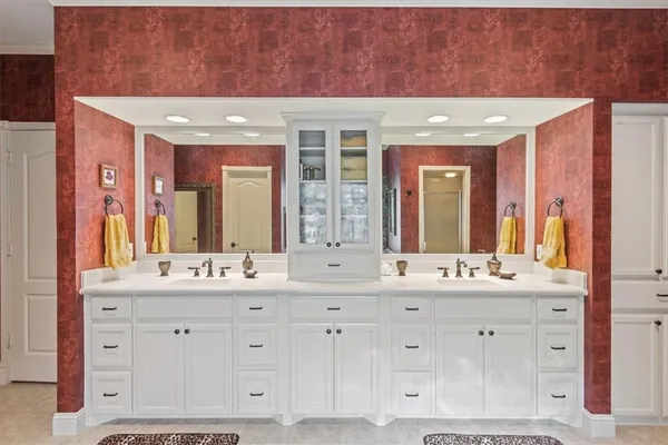 a spacious bathroom with a sink a mirror a bathtub and a shower