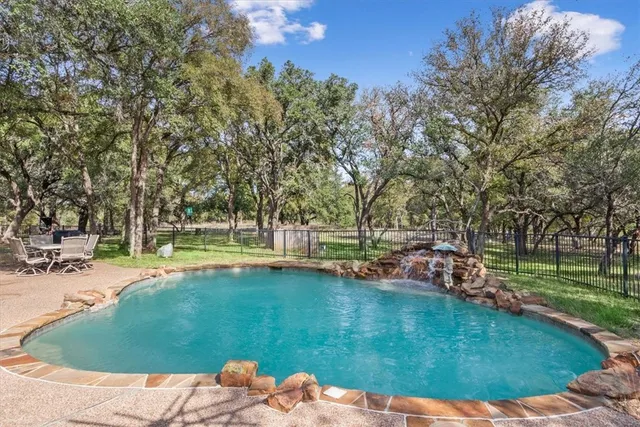 a view of a house with swimming pool and sitting area